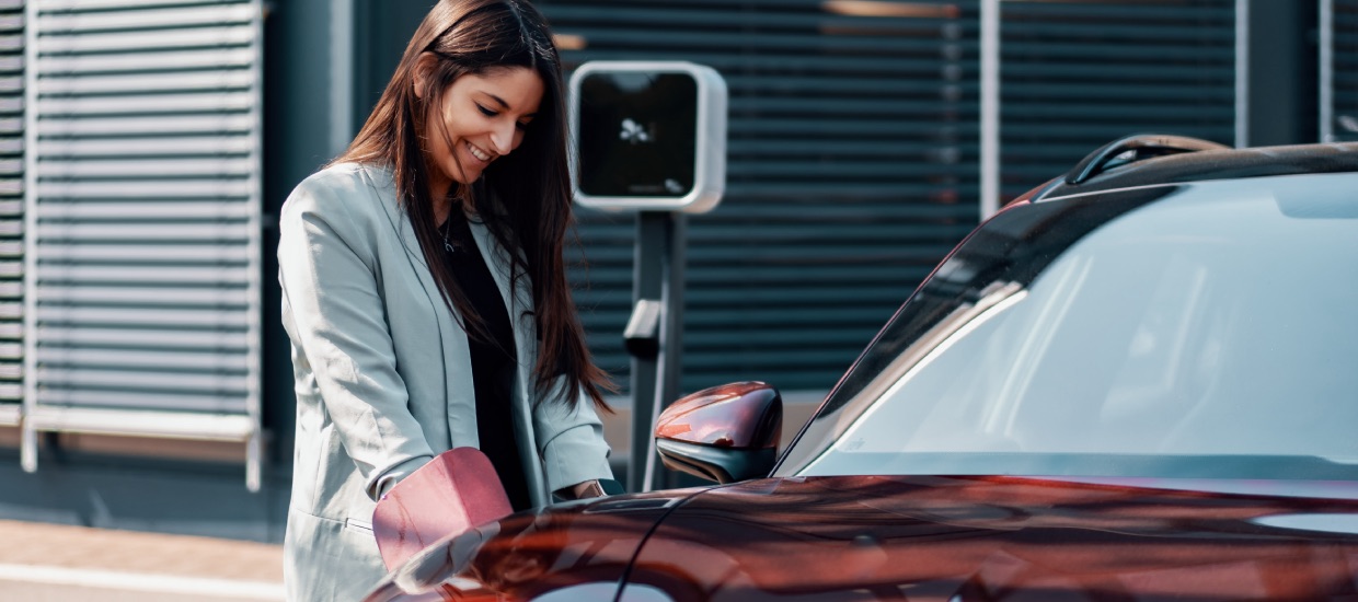 Woman charging an electric vehicle